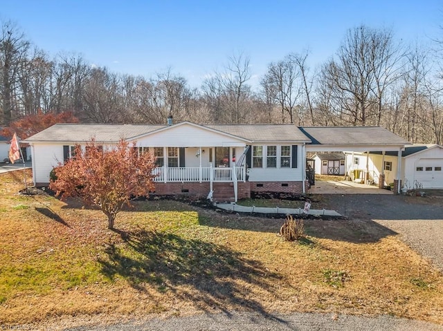 ranch-style home with a front lawn, a porch, and a carport