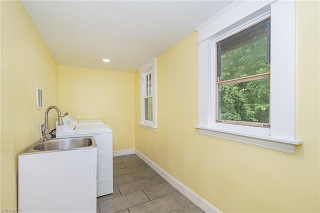 washroom with baseboards, light tile patterned floors, and separate washer and dryer