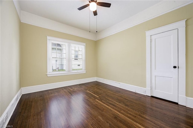 unfurnished room with a ceiling fan, dark wood-style flooring, and baseboards