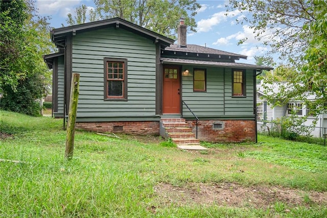 view of front of house with entry steps, a chimney, and crawl space