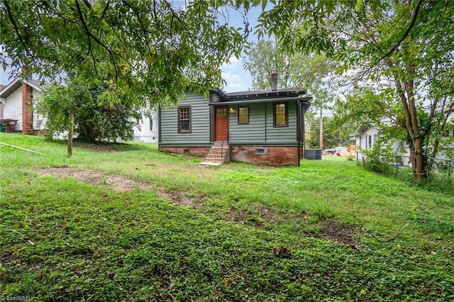 view of front of property featuring crawl space, a chimney, and central air condition unit