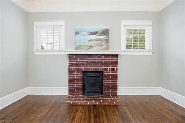 unfurnished living room featuring wood finished floors, crown molding, and baseboards