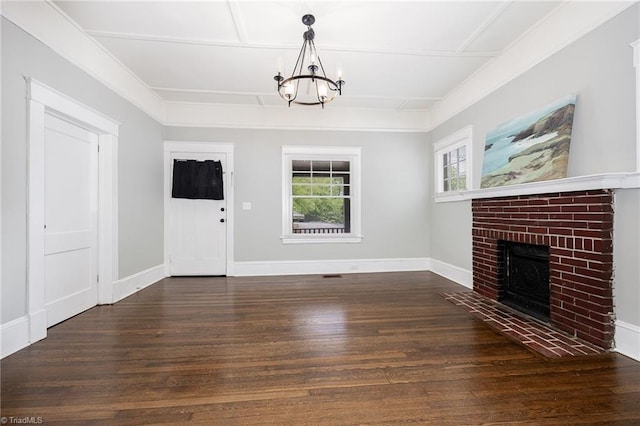entryway with wood finished floors, a chandelier, a fireplace, and baseboards