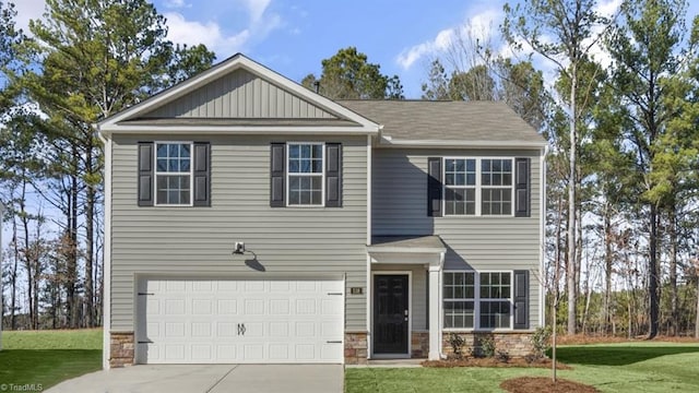 craftsman inspired home featuring a front yard and a garage