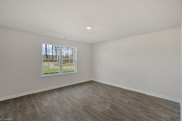 empty room featuring dark wood-type flooring