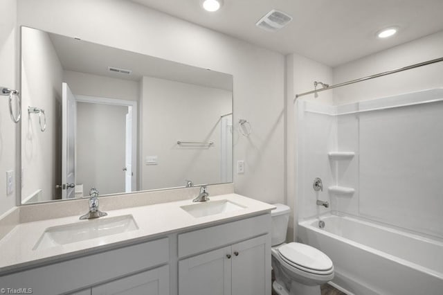 full bathroom with vanity, toilet, and washtub / shower combination