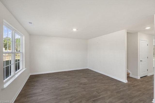 empty room with dark hardwood / wood-style floors