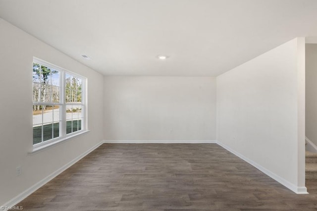 empty room featuring dark wood-type flooring