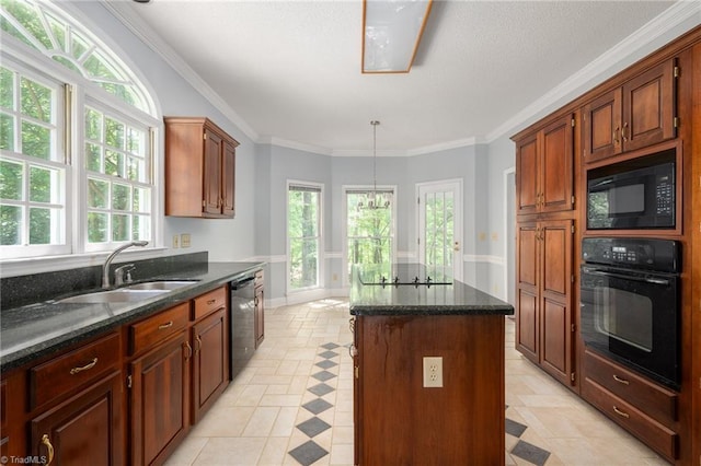 kitchen featuring dark stone counters, a sink, a center island, black appliances, and ornamental molding