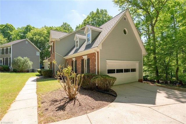 view of front of home featuring brick siding, a front lawn, concrete driveway, and roof with shingles