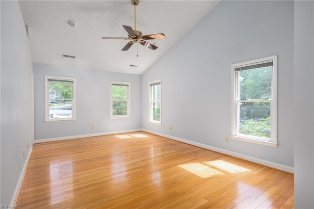unfurnished room featuring high vaulted ceiling, a ceiling fan, visible vents, light wood-style flooring, and baseboards