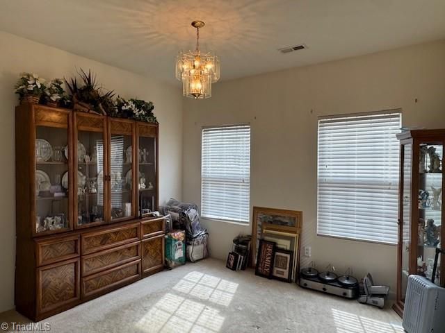 dining area with an inviting chandelier