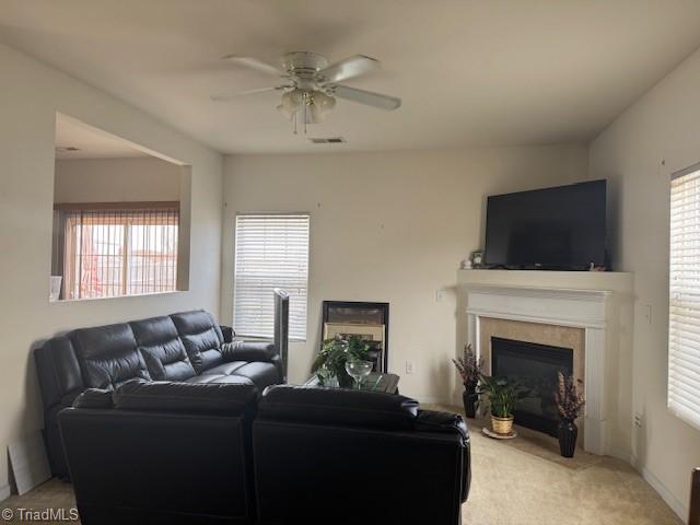 living room with ceiling fan and carpet floors