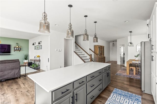 kitchen with freestanding refrigerator, open floor plan, gray cabinets, and light countertops
