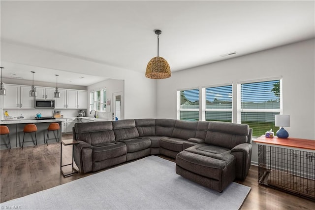 living room with wood finished floors and visible vents