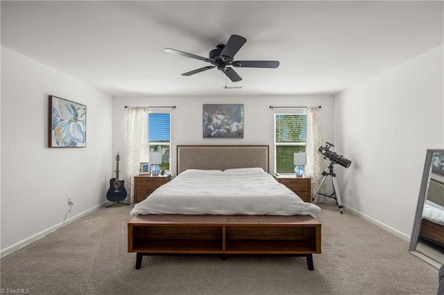 carpeted bedroom featuring baseboards and a ceiling fan