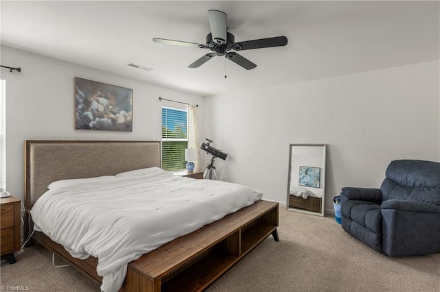 carpeted bedroom with visible vents and a ceiling fan
