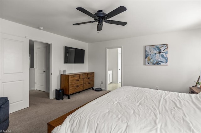 bedroom with connected bathroom, a ceiling fan, baseboards, and carpet