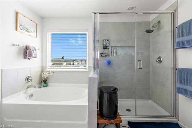 bathroom featuring a garden tub and a stall shower