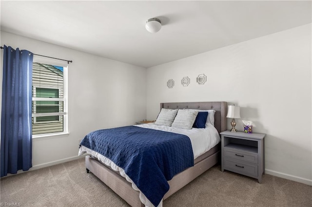 carpeted bedroom featuring baseboards