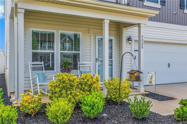 doorway to property with a garage, board and batten siding, concrete driveway, and a porch