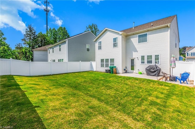 back of house with a lawn, a fenced backyard, and a patio area