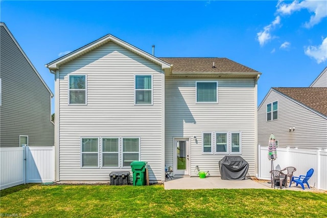 rear view of house featuring a yard, a patio, a gate, and a fenced backyard