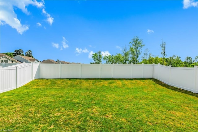 view of yard with a fenced backyard