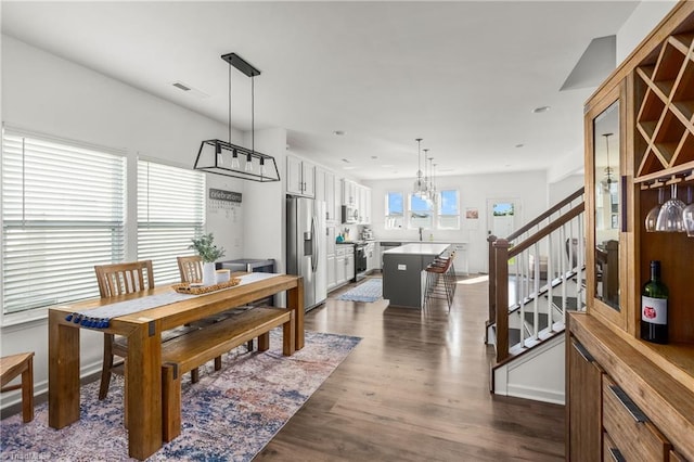 dining space with stairs, recessed lighting, visible vents, and dark wood-style floors