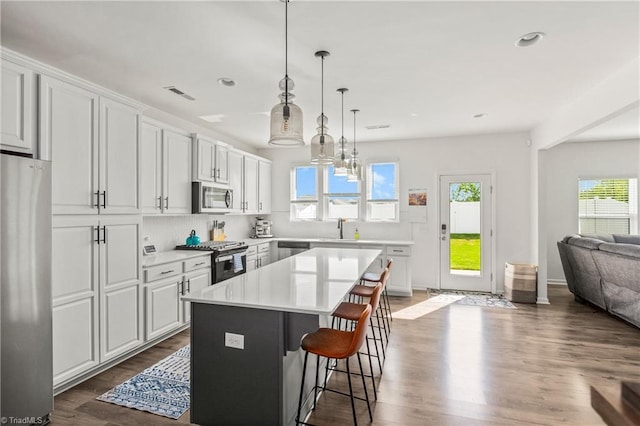 kitchen with visible vents, recessed lighting, light countertops, a center island, and stainless steel appliances