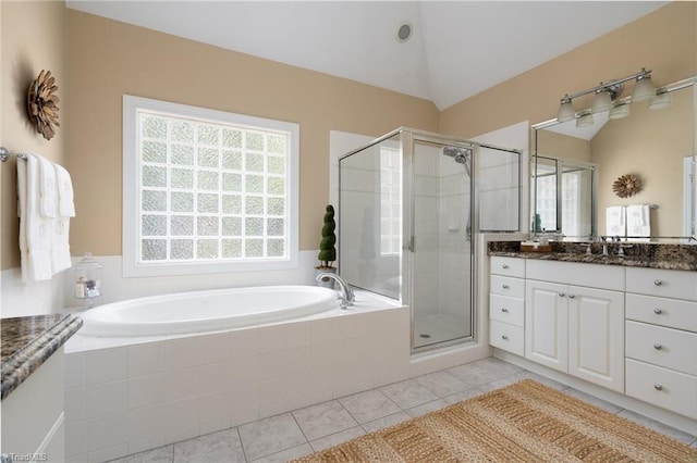 bathroom featuring vanity, lofted ceiling, a shower stall, tile patterned floors, and a bath