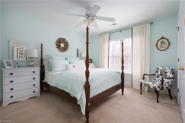 bedroom with visible vents, light carpet, and ceiling fan