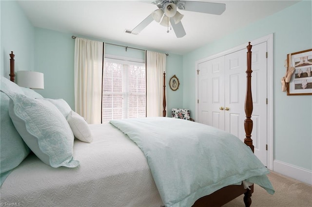 bedroom with visible vents, baseboards, ceiling fan, carpet floors, and a closet