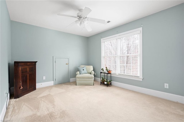 sitting room featuring visible vents, a ceiling fan, baseboards, and carpet floors