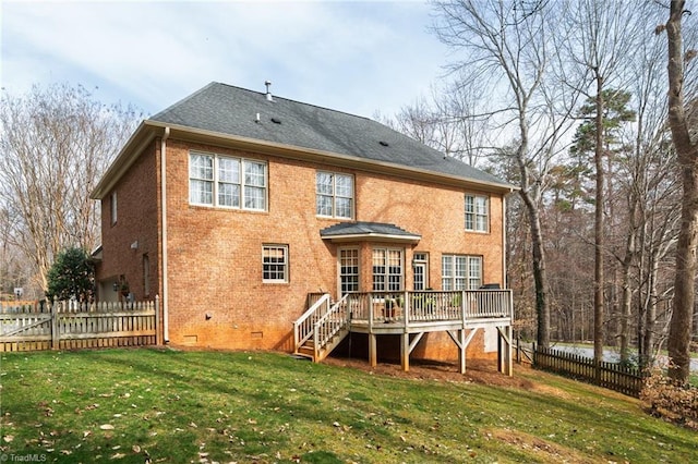 back of property with fence, a yard, crawl space, a deck, and brick siding