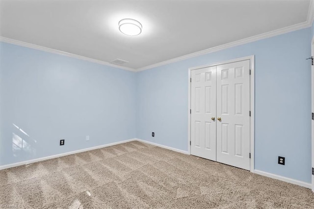 unfurnished bedroom featuring crown molding, baseboards, and carpet floors