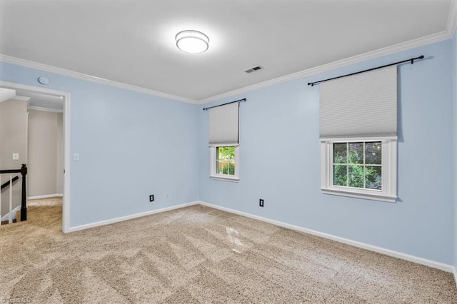 unfurnished room with crown molding, baseboards, visible vents, and carpet