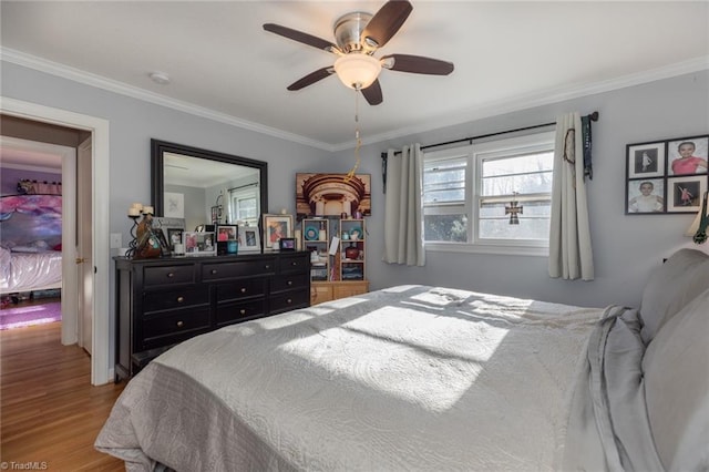 bedroom with ceiling fan, crown molding, and wood-type flooring