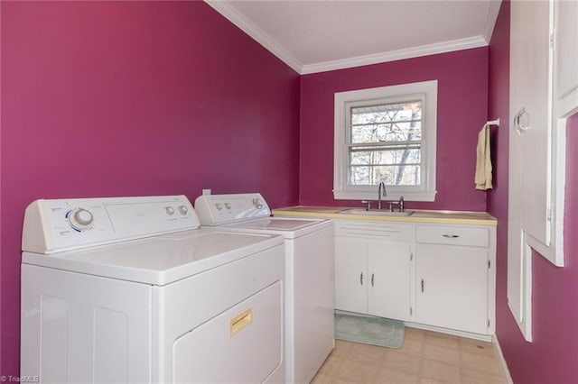 laundry area featuring cabinets, sink, separate washer and dryer, and crown molding