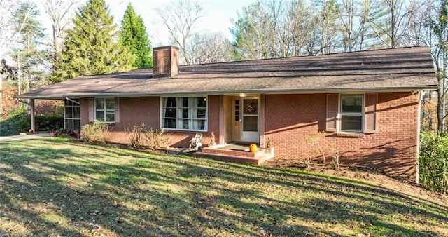single story home with brick siding, a chimney, and a front lawn