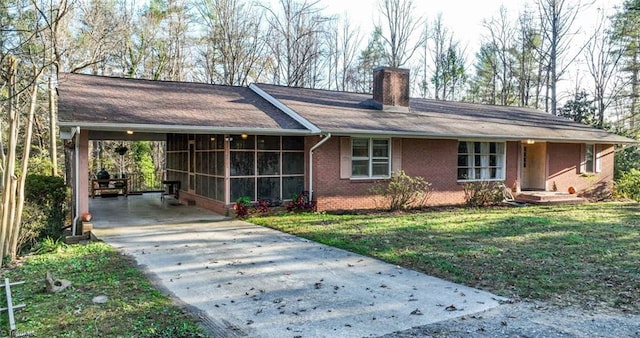 7715 W NC Highway 268, Wilkesboro, NC 28697 - ranch-style home featuring driveway, a chimney, an attached carport, brick siding, and a sunroom
