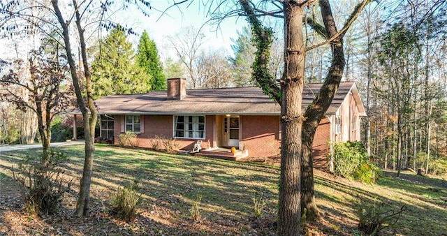 7715 W NC Highway 268, Wilkesboro, NC 28697 - single story home featuring a chimney, a front yard, driveway, and brick siding