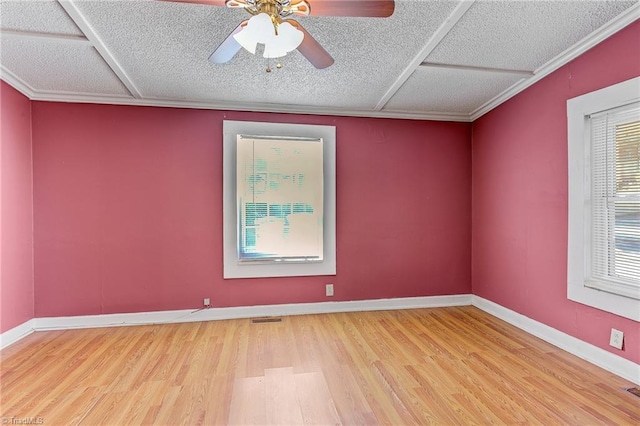 spare room with ceiling fan, hardwood / wood-style flooring, crown molding, and a textured ceiling