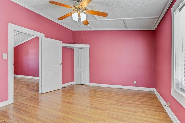 unfurnished room featuring ornamental molding, ceiling fan, light hardwood / wood-style floors, and a textured ceiling