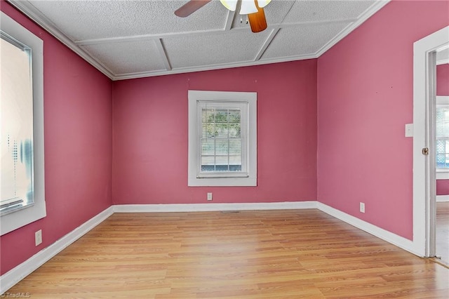 spare room featuring ceiling fan, light hardwood / wood-style floors, crown molding, vaulted ceiling, and a textured ceiling