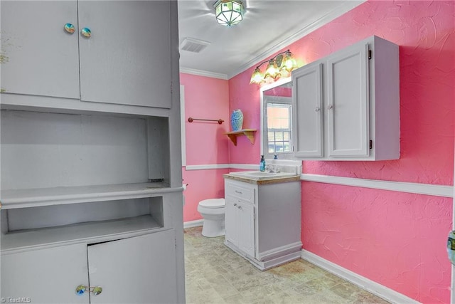 bathroom with vanity, crown molding, and toilet