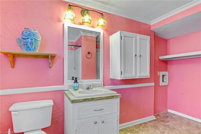 bathroom with crown molding, vanity, and toilet