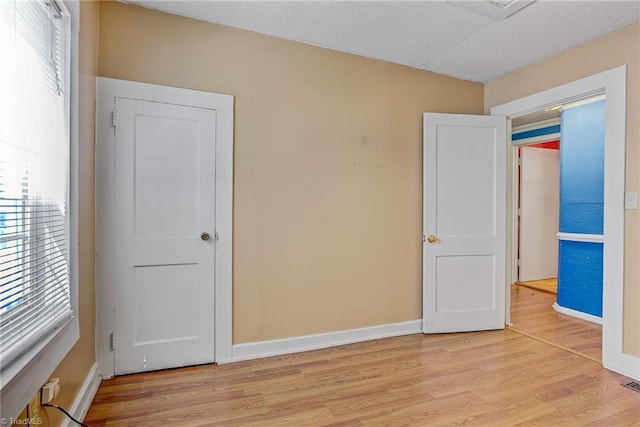 unfurnished bedroom featuring light wood-type flooring