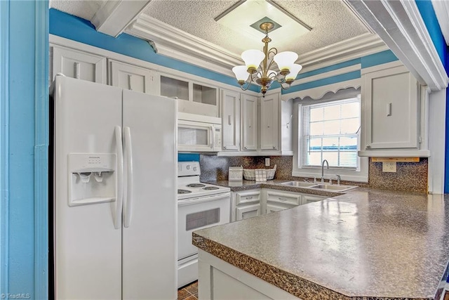 kitchen featuring white cabinets, hanging light fixtures, sink, and white appliances