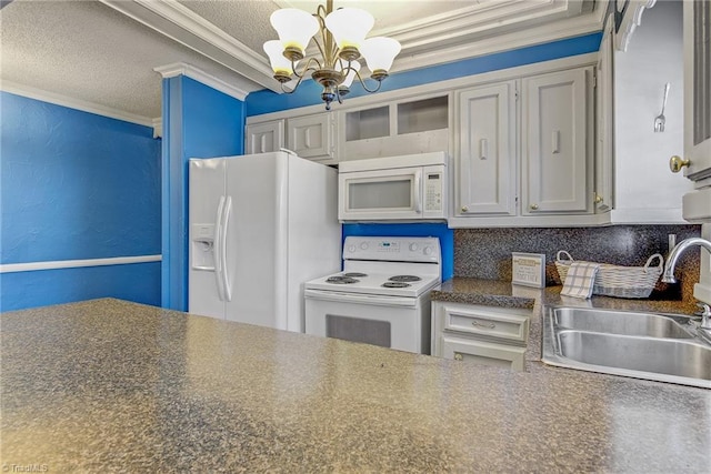 kitchen featuring tasteful backsplash, white appliances, crown molding, sink, and a notable chandelier